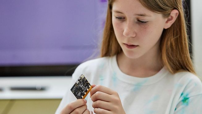 pupil examining back of micro:bit board