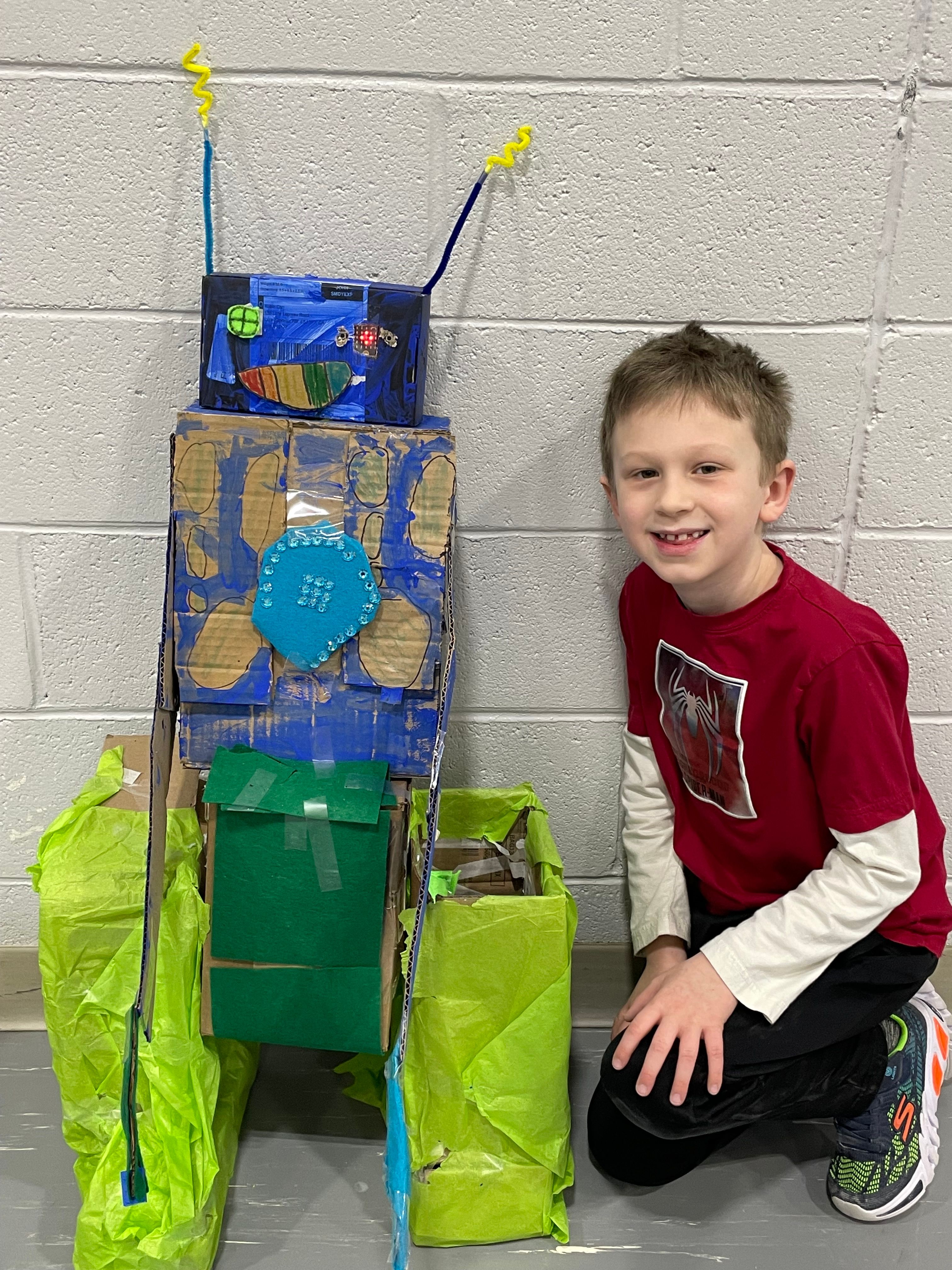 Student poses with his bot.