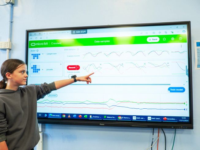 A girl points at her data on the CreateAI screen