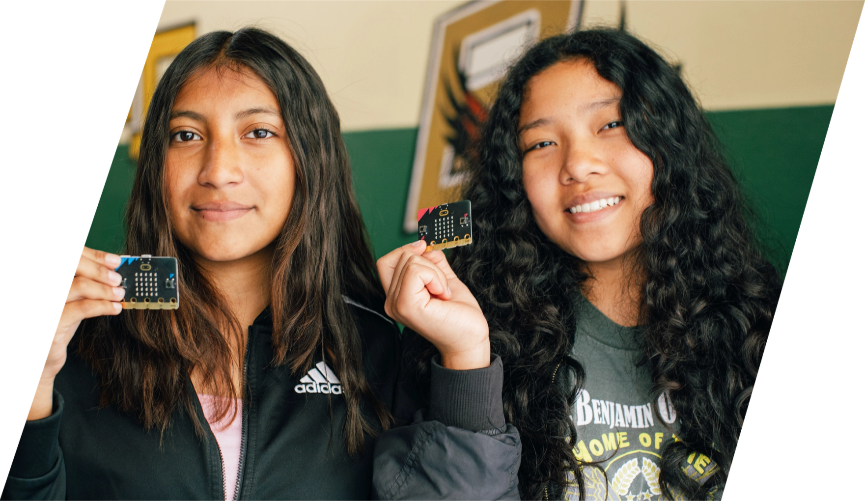 children in class smiling and holding micro:bits