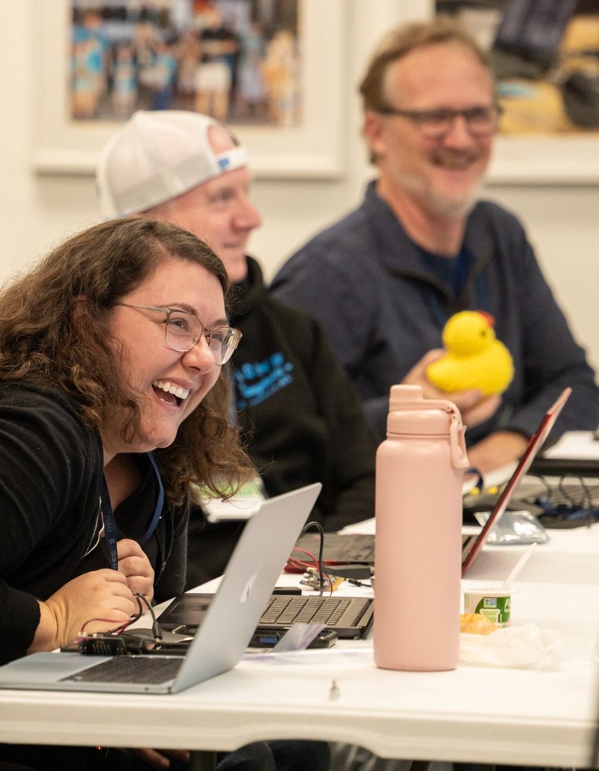 Teachers smiling and laughing at a teacher training event