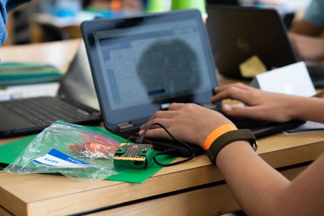 A student coding their micro:bit on a laptop