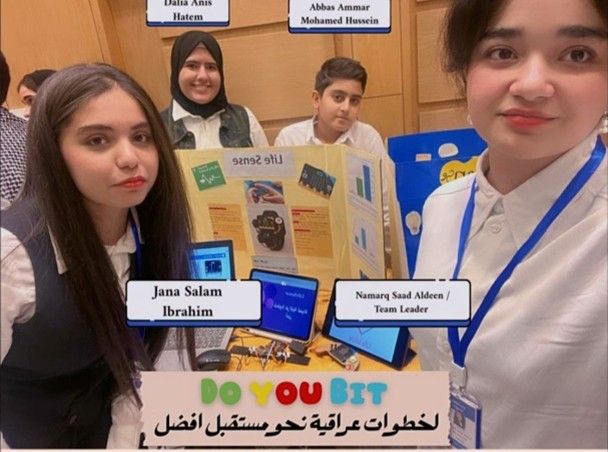 Students pose with their presentation poster and a prototype of their project.