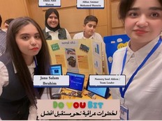 Students pose with their presentation poster and a prototype of their project.