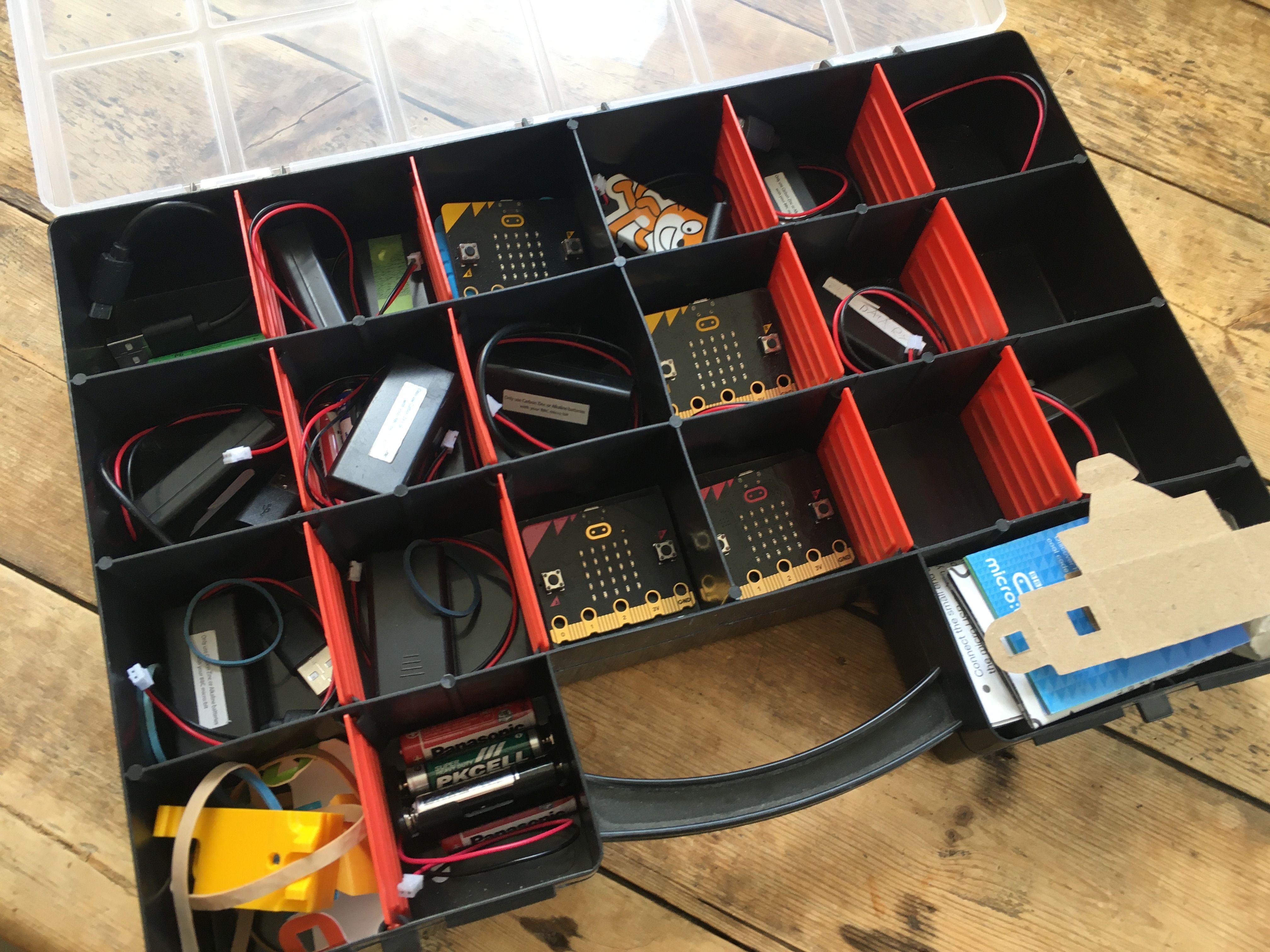 micro:bits stored in inexpensive craft tray