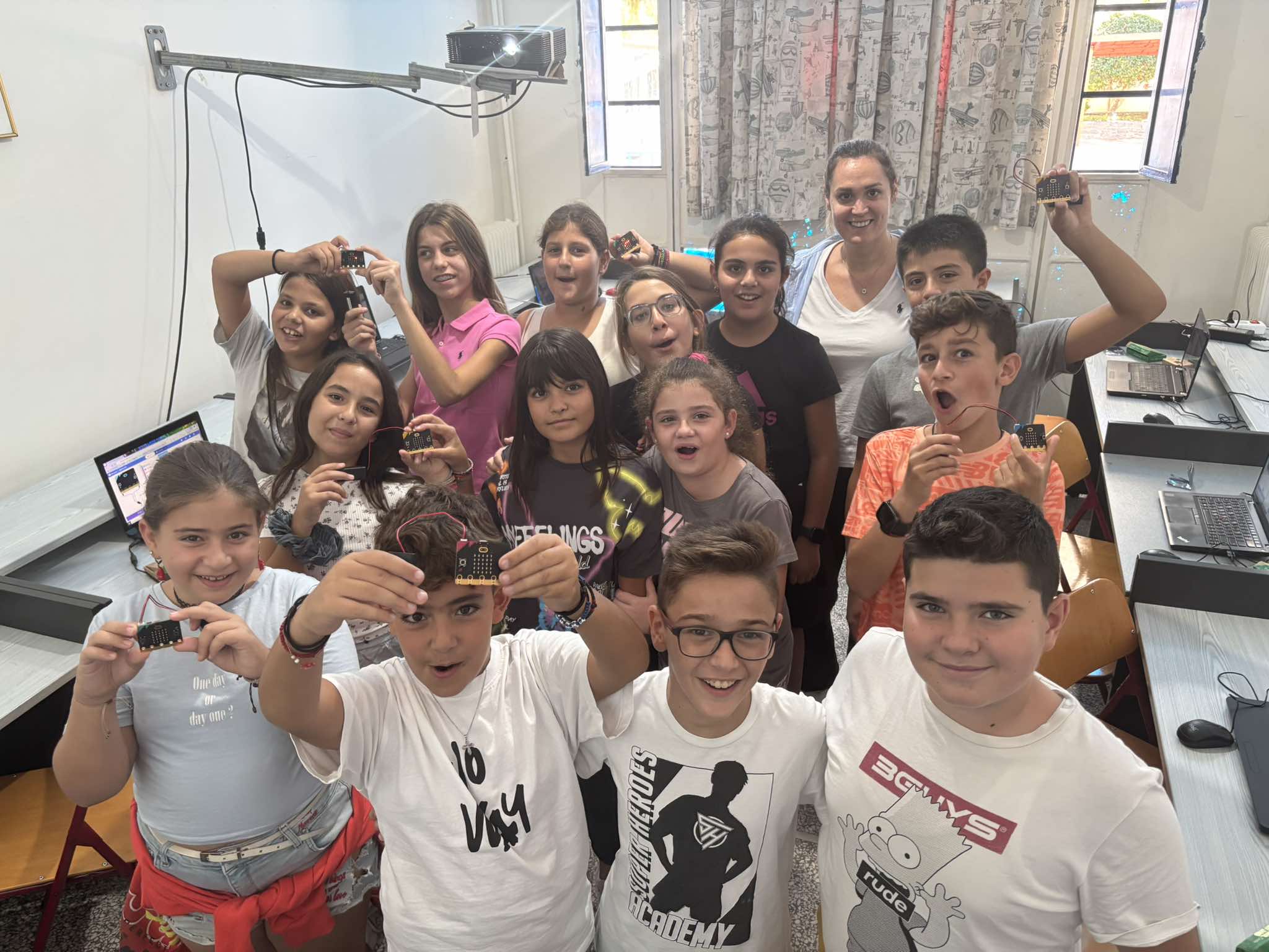 Students holding up their micro:bits while working on the Hero of the Clean Sea project.