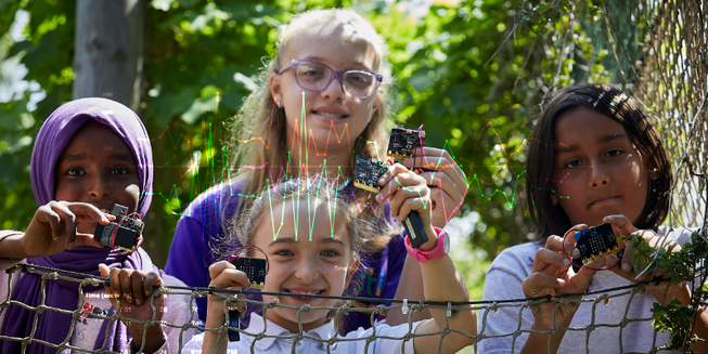 students using the BBC micro:bit outdoors