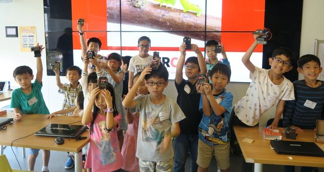 Children in Singapore holding micro:bits