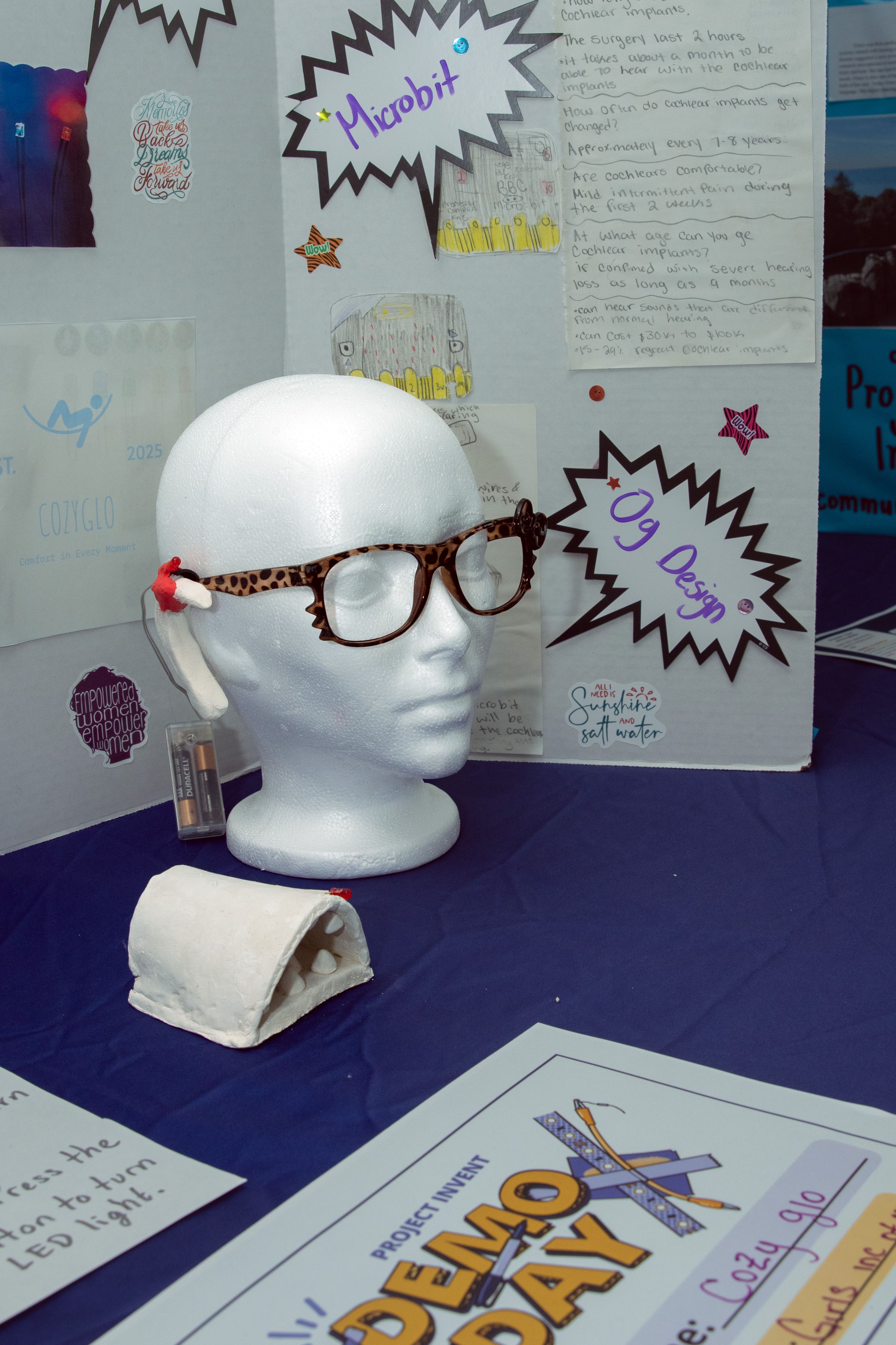 Image shows a styrofoam head wearing the cozy glo prototype. 