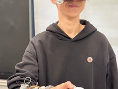Student wears the Novavision device and demonstrates how it works.