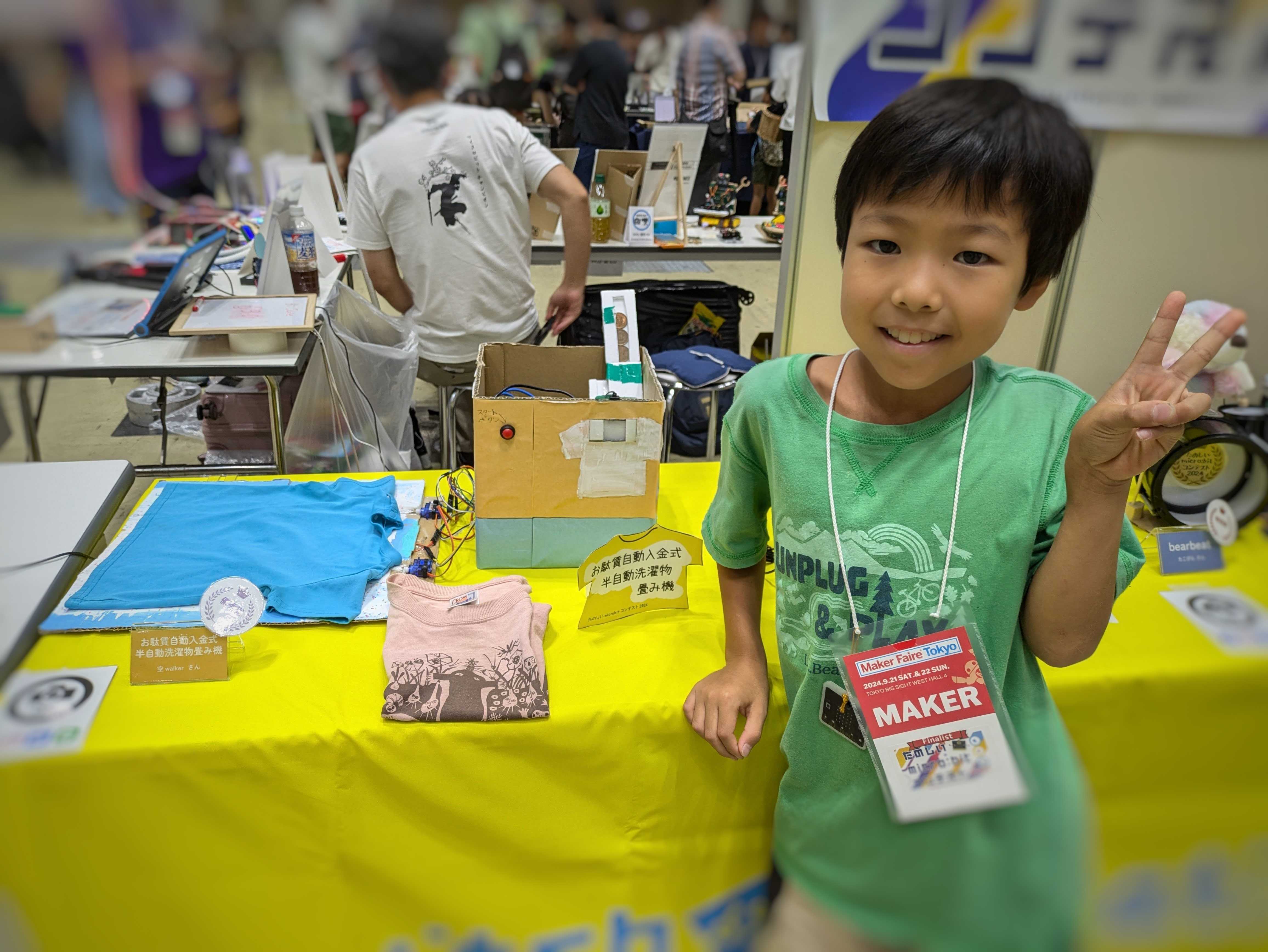 Student poses with the automatic laundry folding machine prototype.