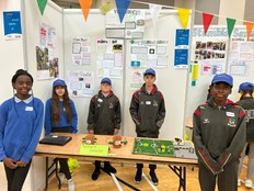 Students standing with a prototype of The Pitch.