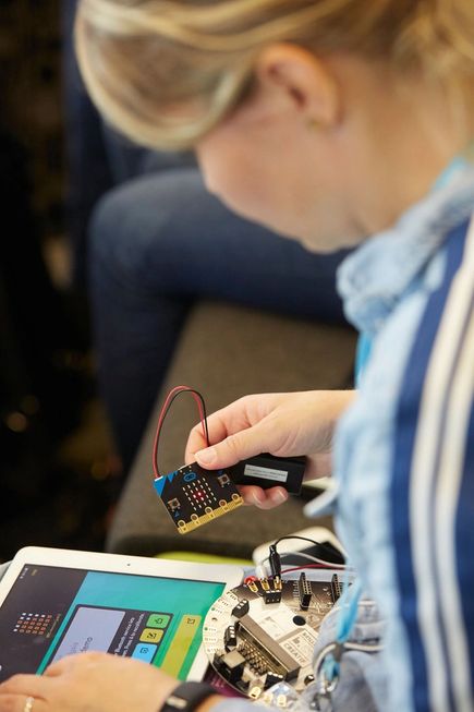 a teacher working with micro:bit
