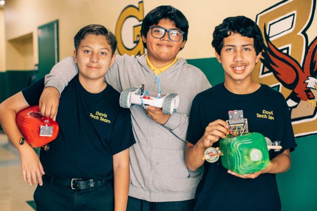 Three boys from Davis Middle School pose proudly with their coding projects many of which use the BBC micro:bit