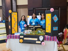Students pose with their presentation poster and a prototype of their project.
