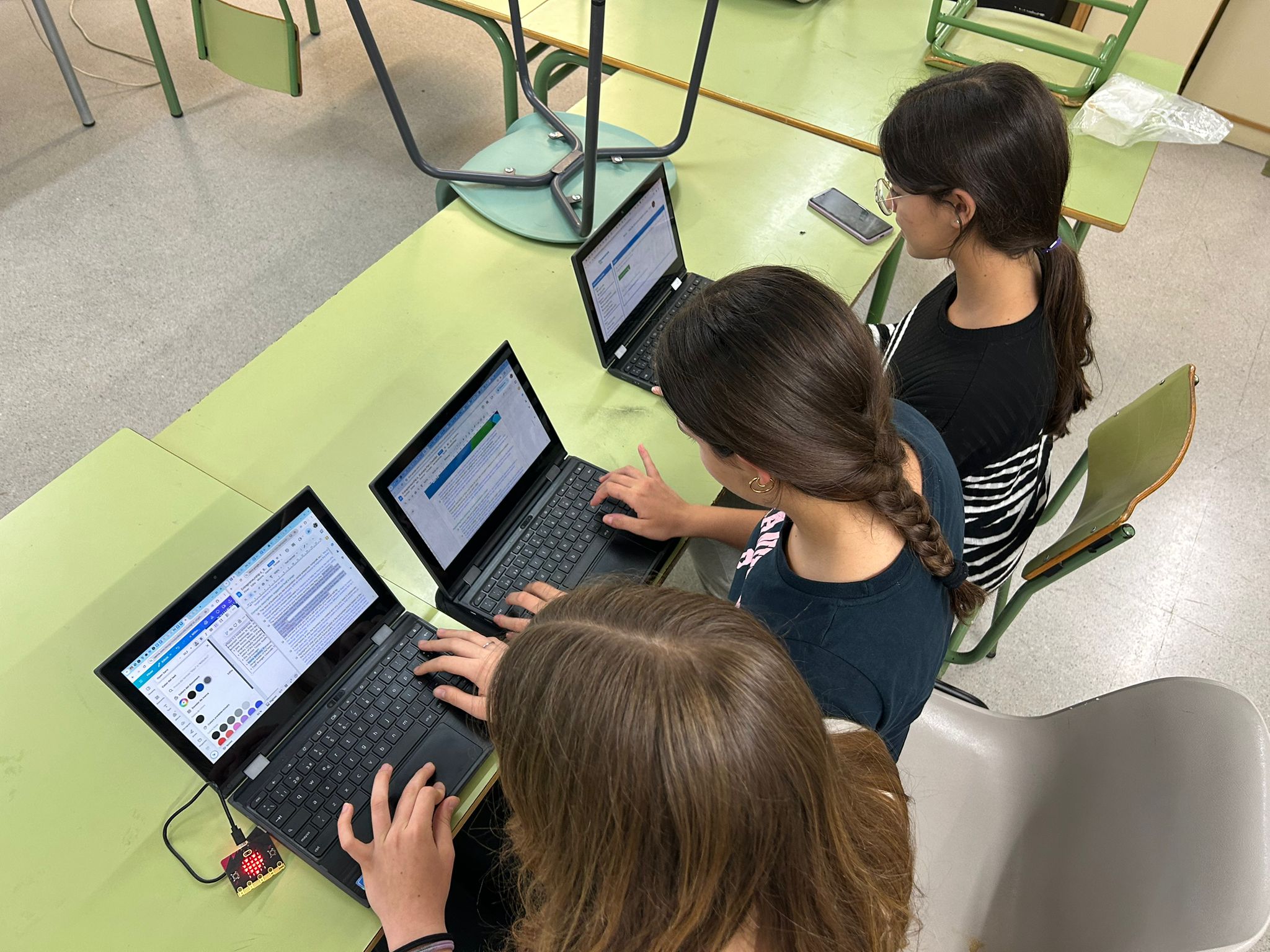 Students working on their laptops to create the Butterfly project. 