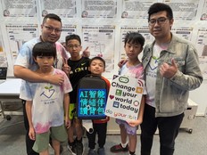 Students pose with their presentation posters.