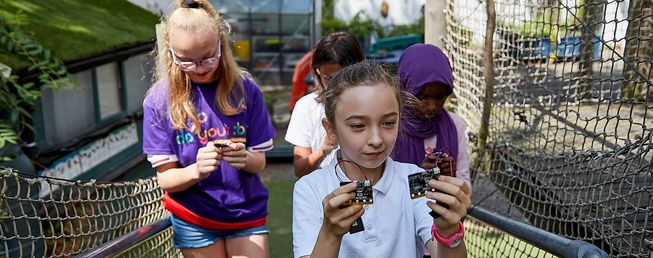 Students testing micro:bit projects outdoors