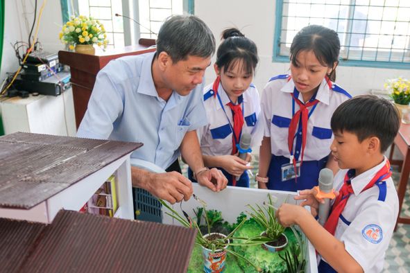 Students working on the Smart Utility Home with a teacher.