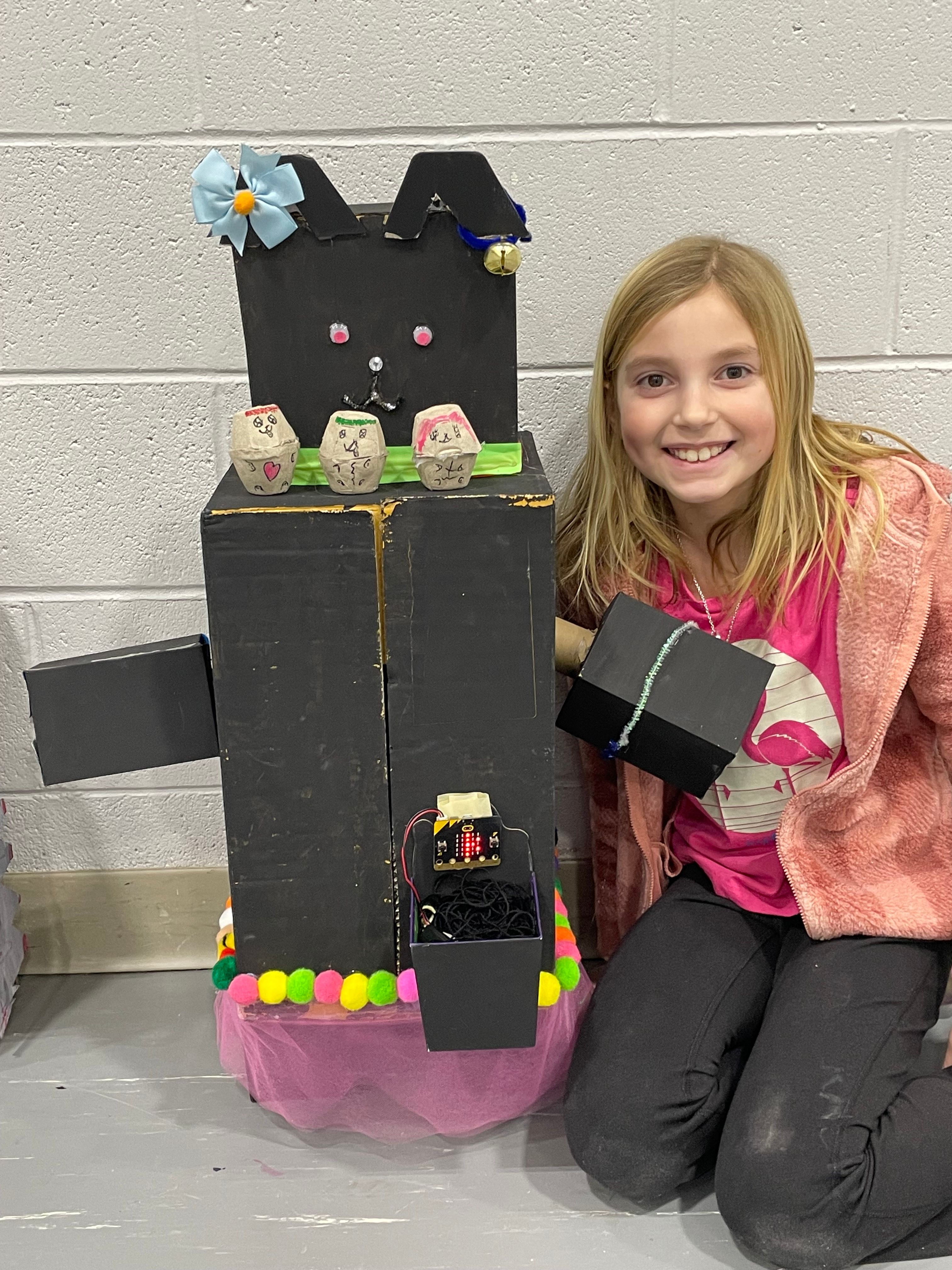 Student poses with her Bot.