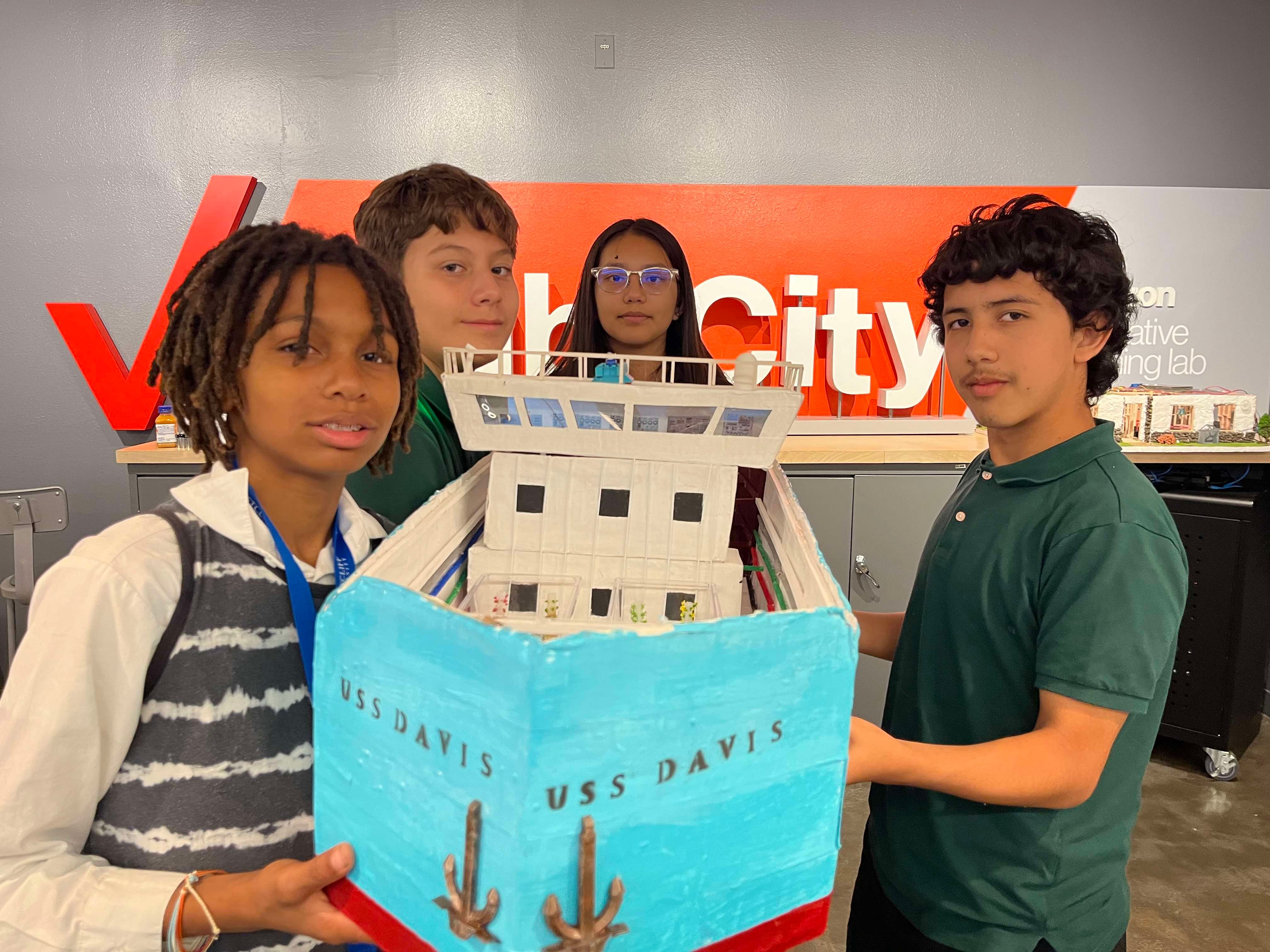 Students display the bow of the Aquaponics Ship prototype.