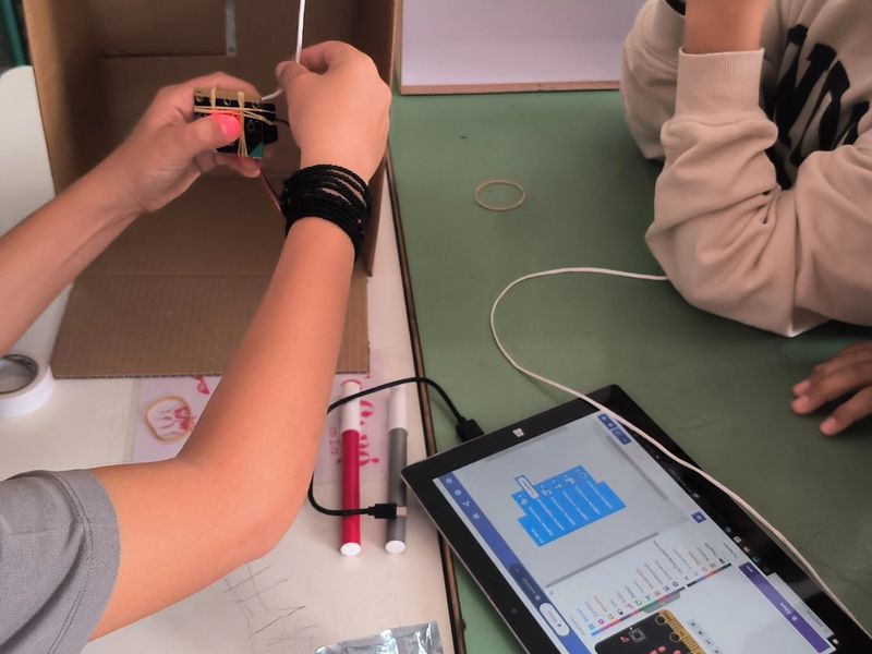 Close up of students working on their project prototype.