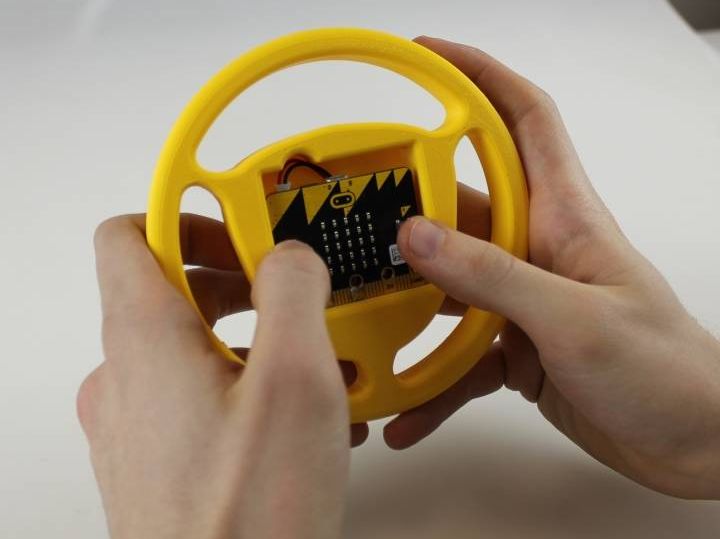 A 3d printed mount for the micro:bit shaped like a steering wheel.