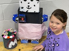 Student poses with her Bot.