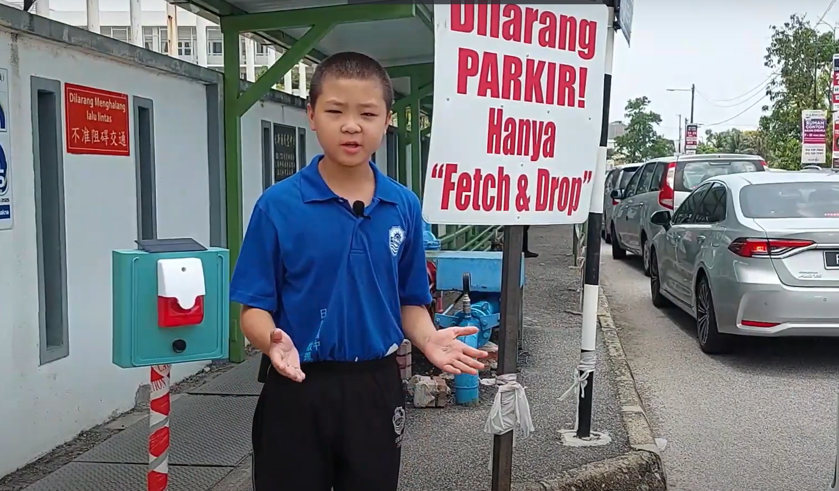 Student presents the Park Guard prototype near a parking area.