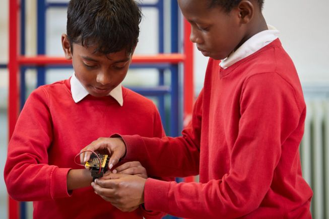 Two boys wearing the micro:bit