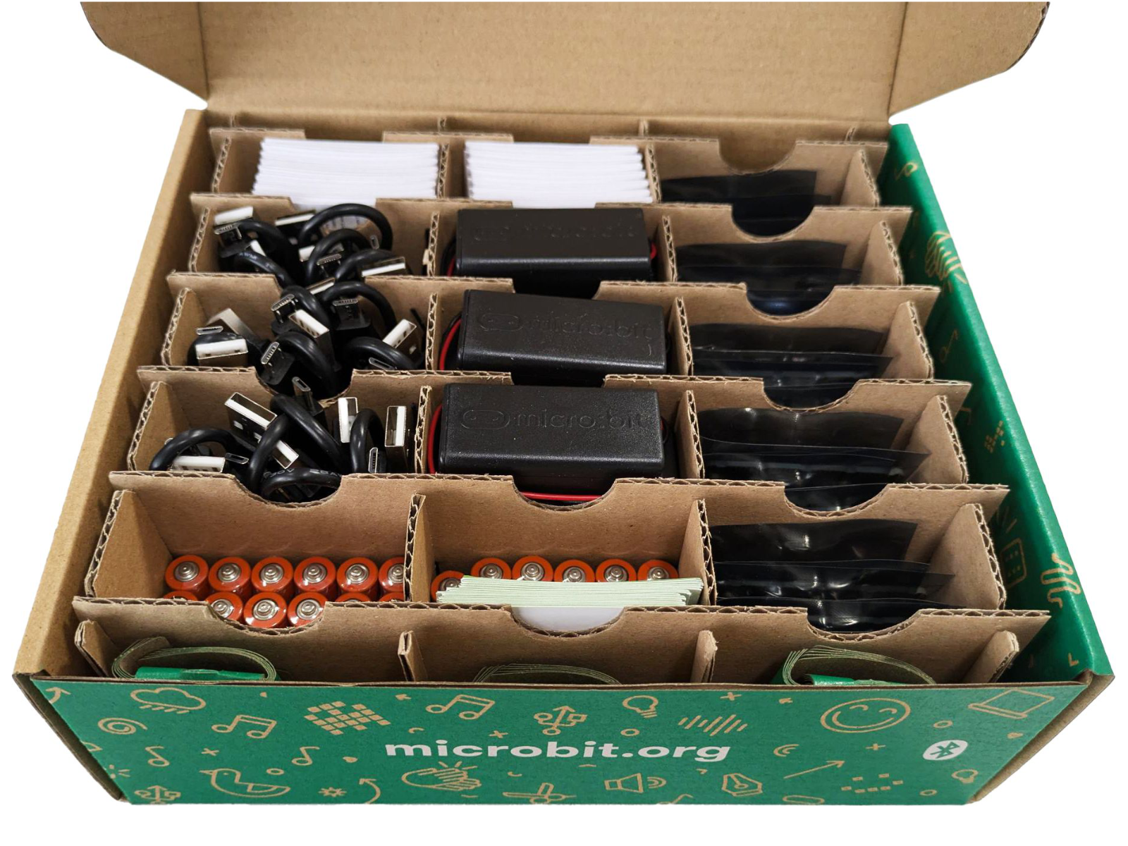 One of the boxes opened, showing slots containing cables, batteries, battery packs that are used with the micro:bits