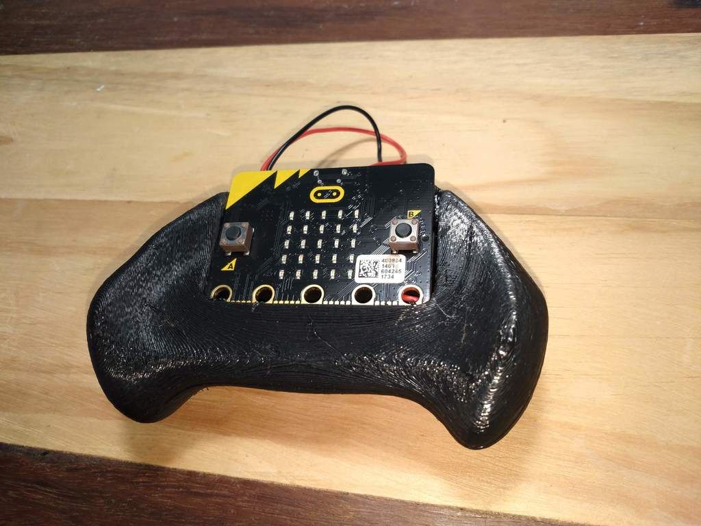 A 3d printed mount for the micro:bit shaped like a game controller to allow it to fit comfortably between palms of hands.