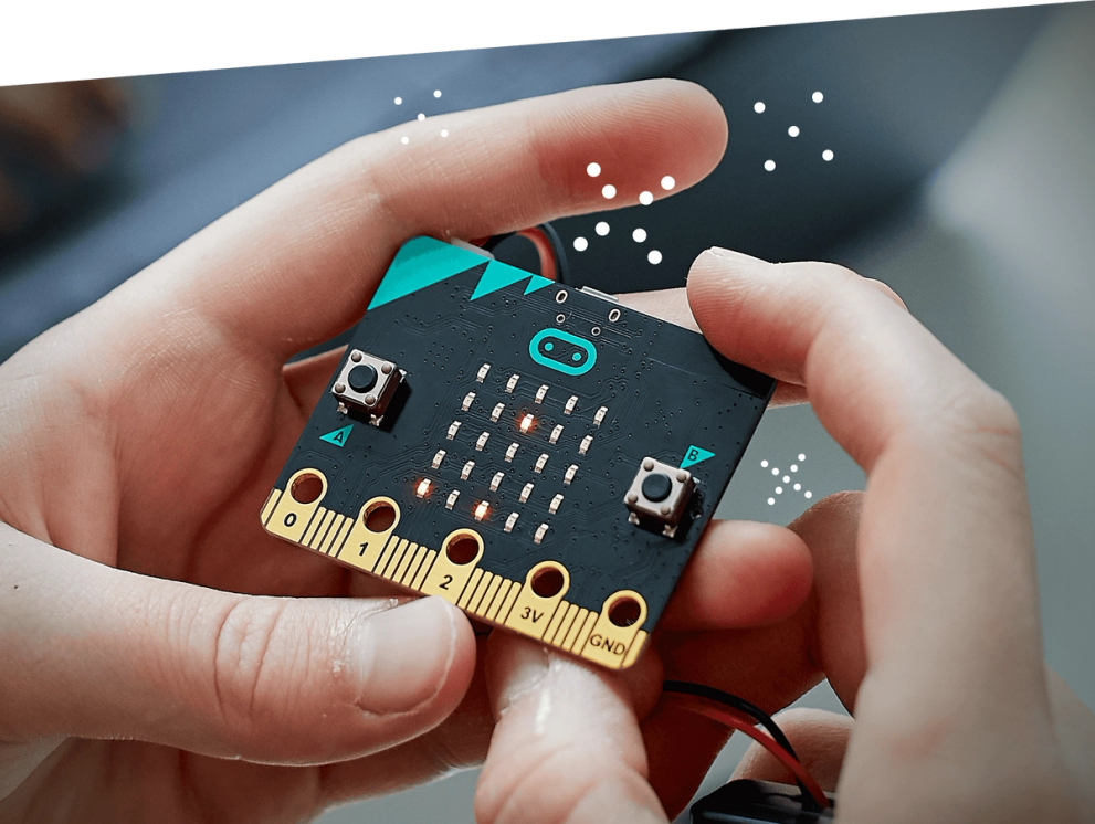 a child's hands holding a BBC micro:bit