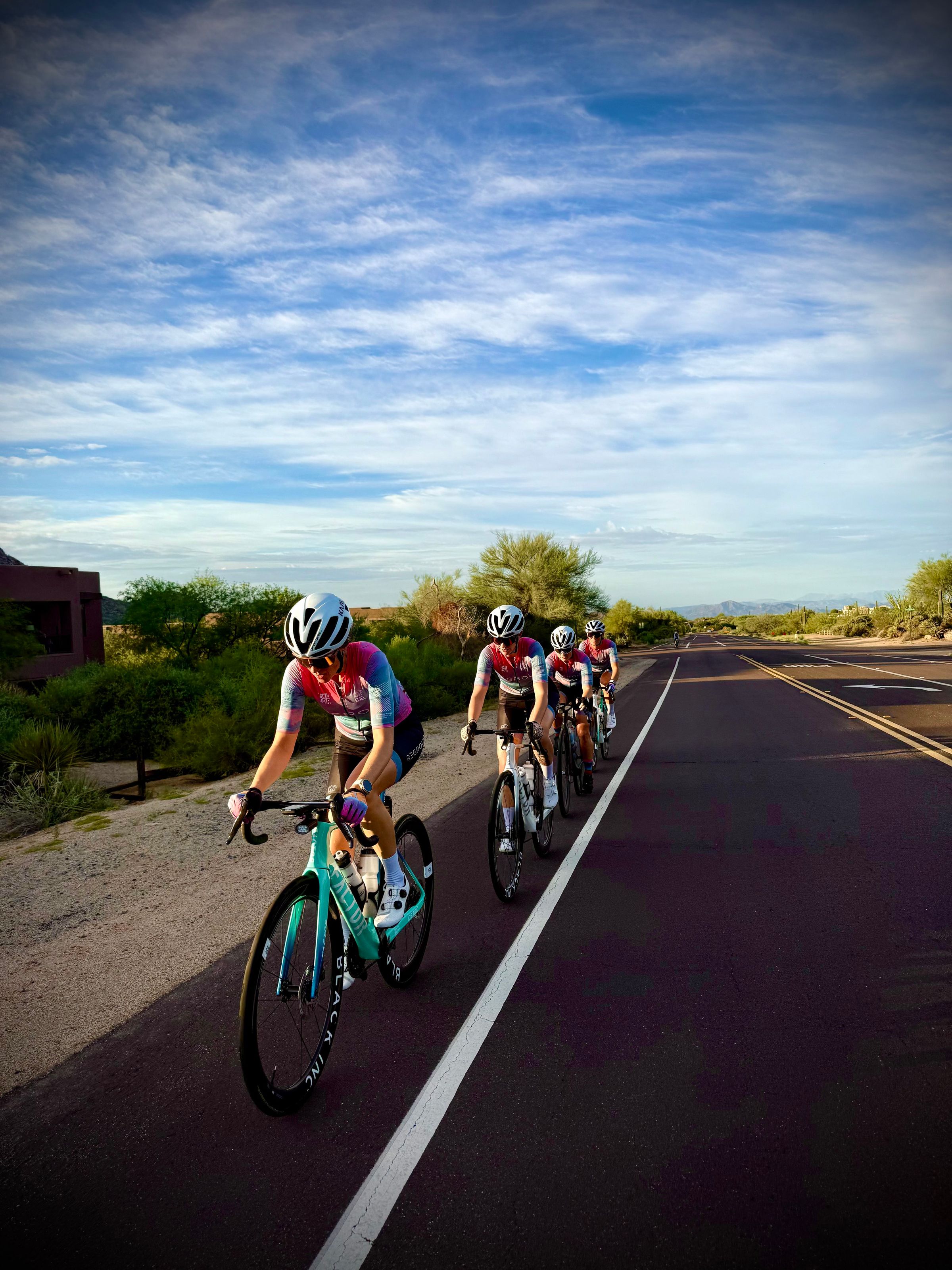 A group riding out on an open desert road