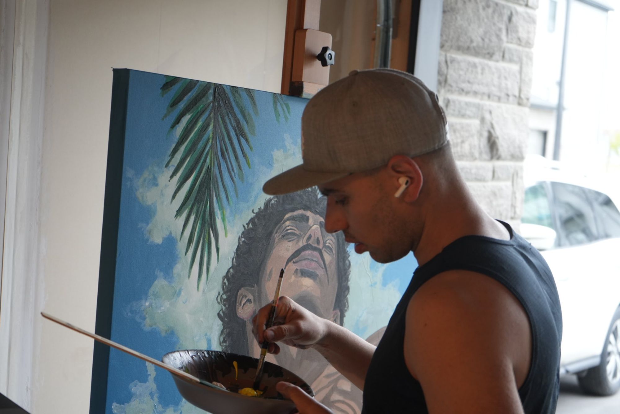 Candid of Manuel painting in his studio 