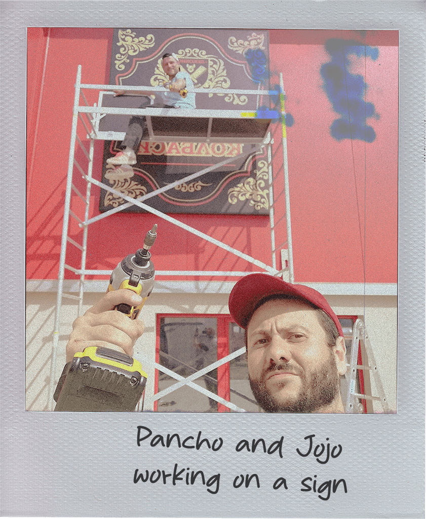 Pancho and Jojo working on a sign