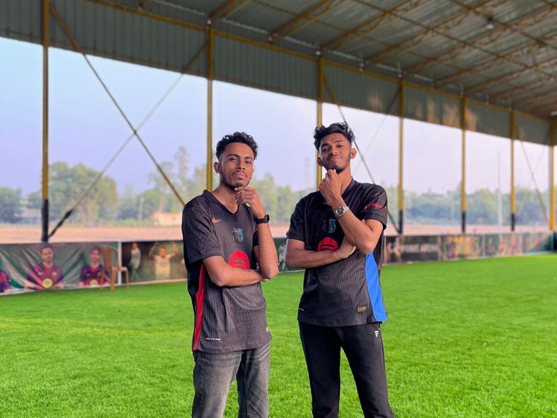 Action shot of football players competing for the ball during a match on the indoor turf.