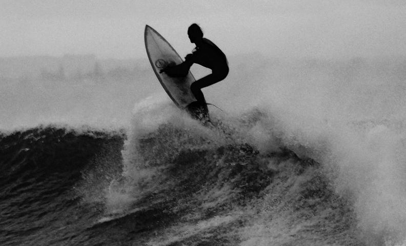 Черно-белая фотография человека, занимающегося серфингом