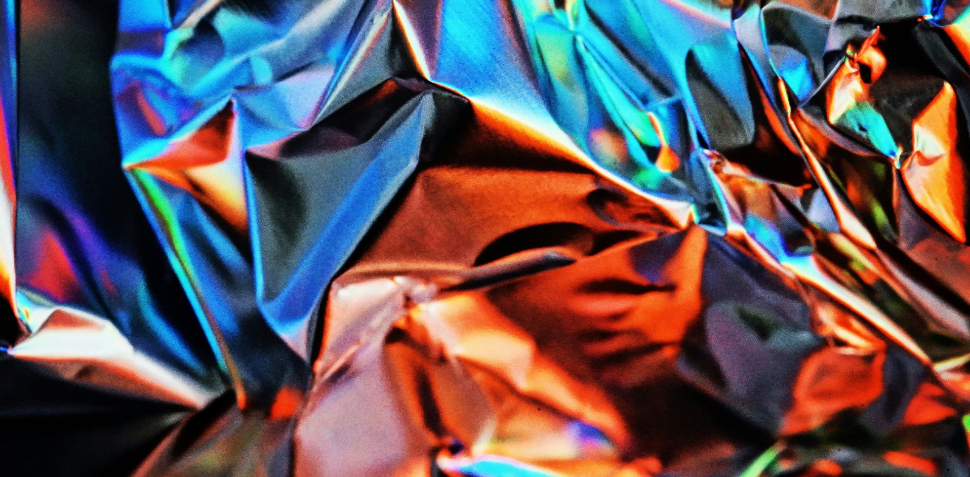 Kuvituskuva, metallin väristä materiaalia, jota on puristettu kasaan