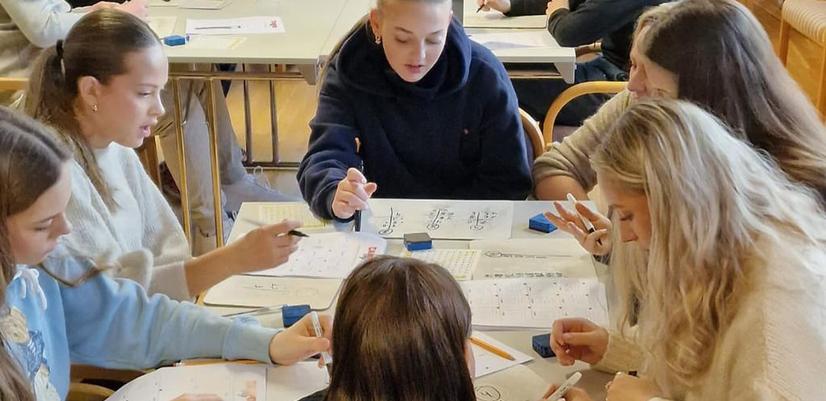 En grupp flickor får lärandestöd från en lärare på Campus UNG.