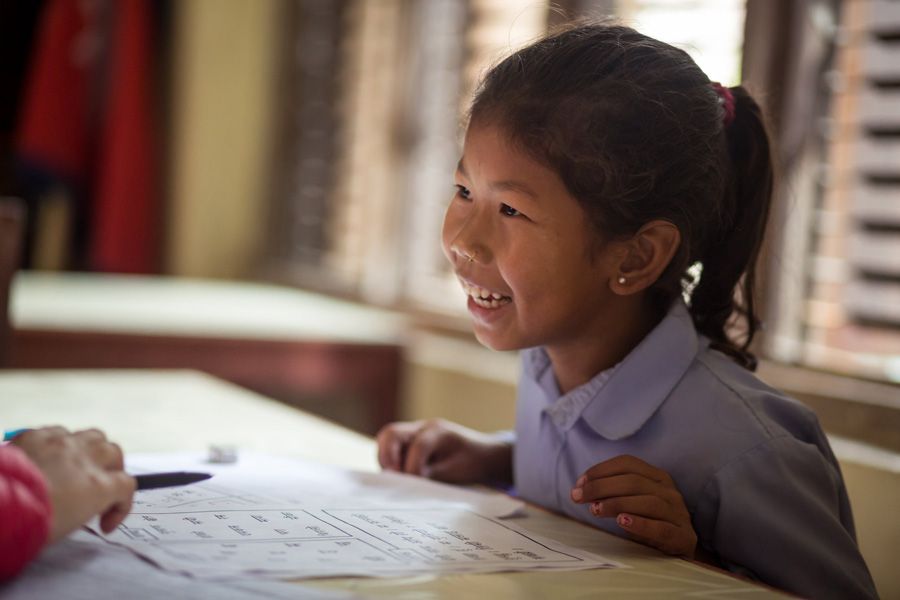 A young pupil receives learning support