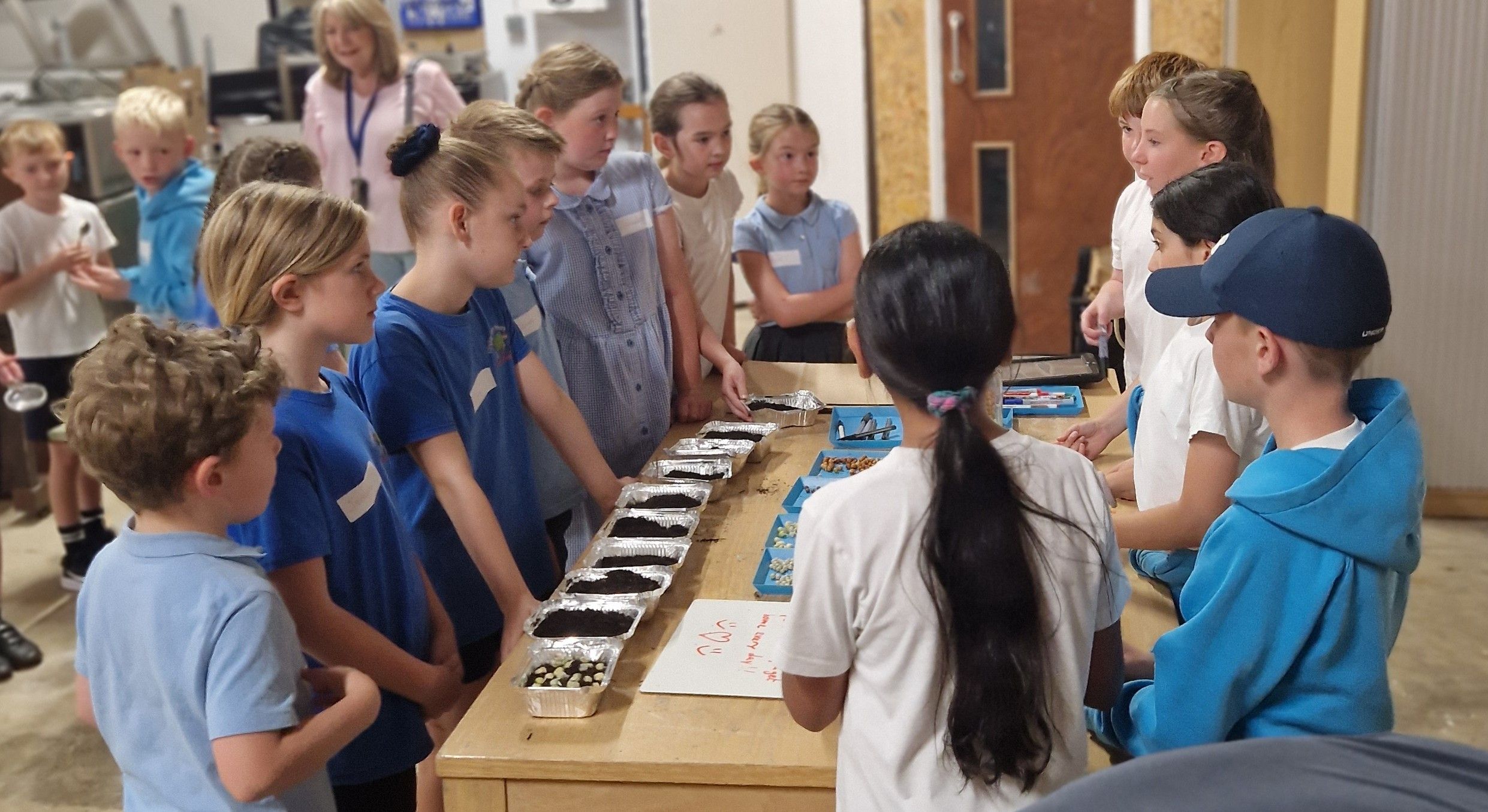 Pupils gather around a table to learn about sustainable food growing.