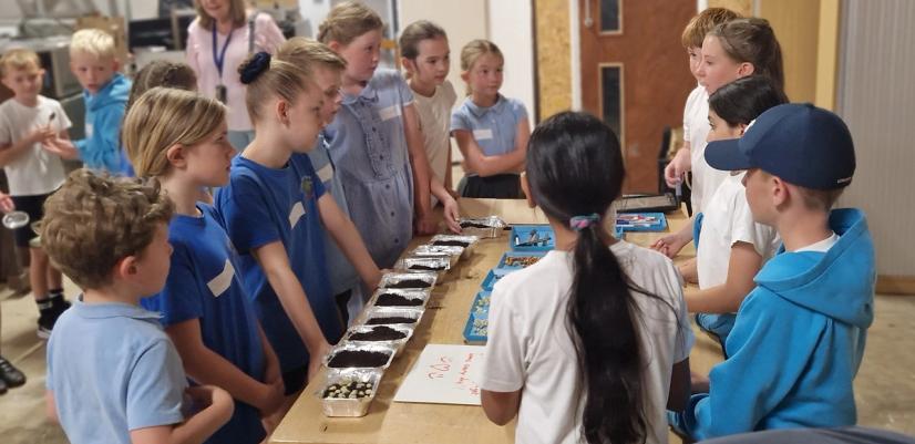 Pupils gather around a table to learn about sustainable food growing.