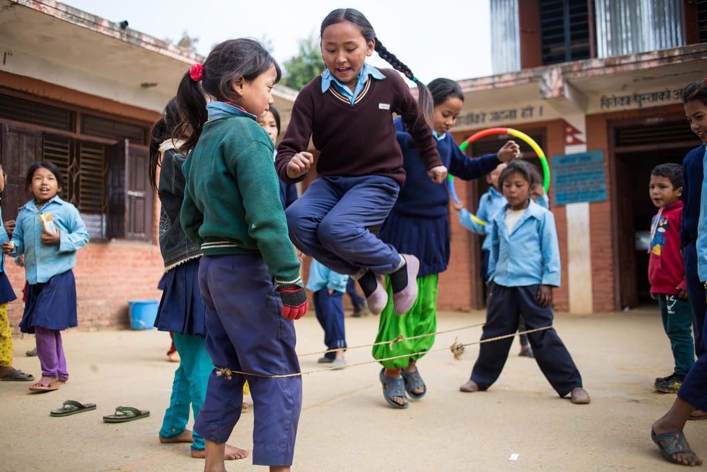 A group of children play in the school yard at Bhanu Jana Secondary School.