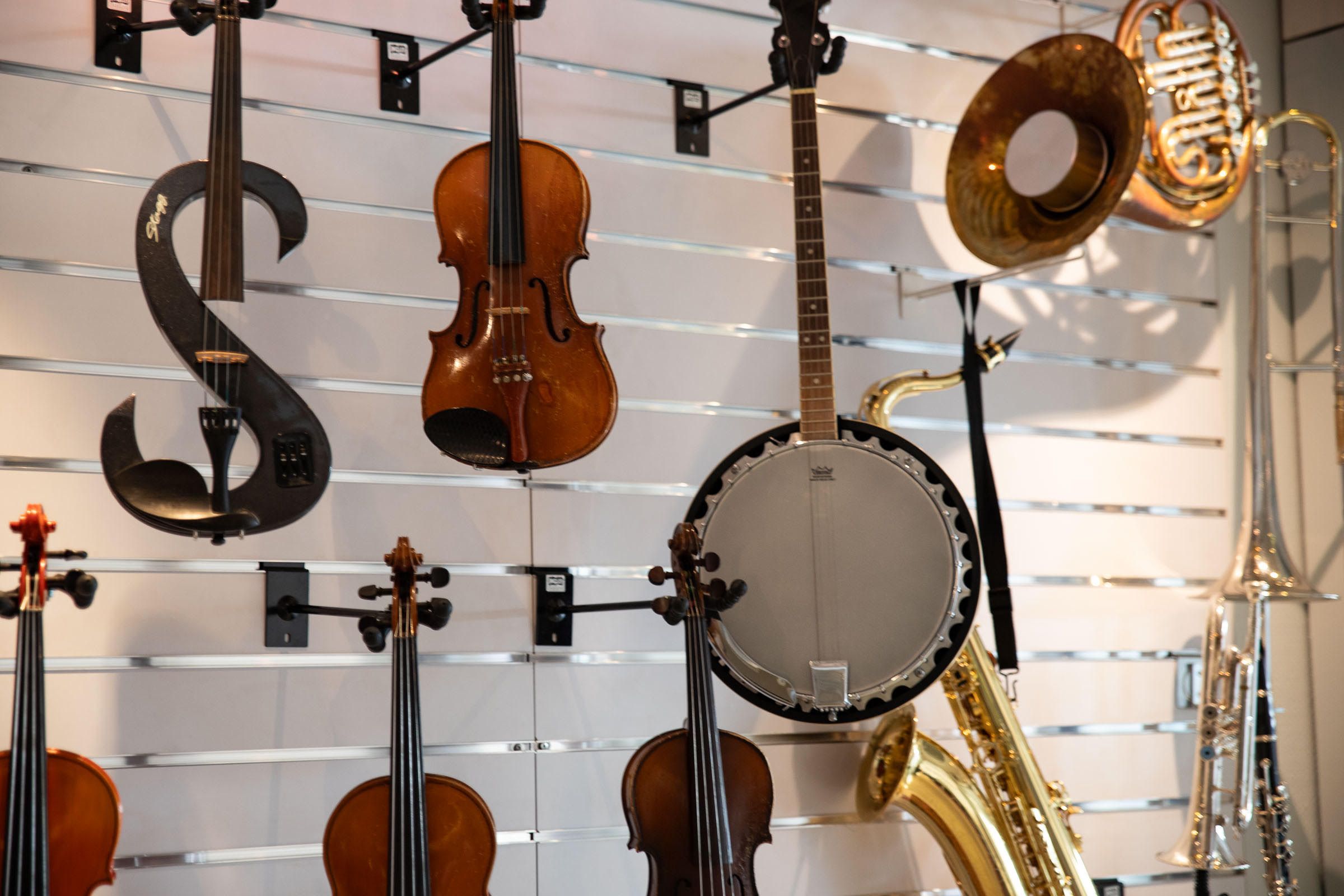 Brass and string instruments line the walls at Give Music a Chance.