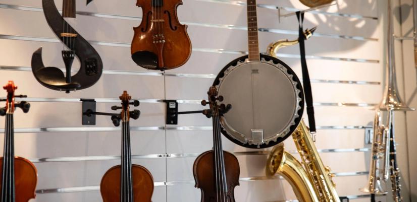 Brass and string instruments line the walls at Give Music a Chance.