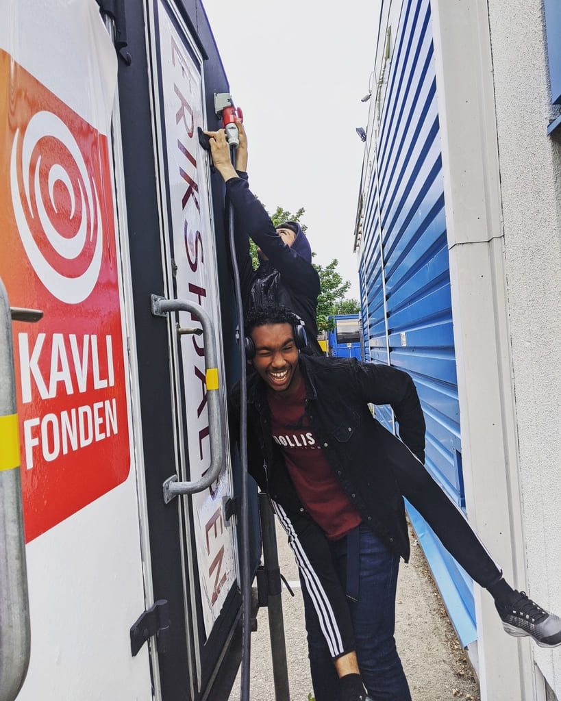 To tenåringsgutter foran vognen «Shark tank». Det er ungdommenes eget sted, som de har pusset opp selv og bruker som studio og aktivitetsrom.