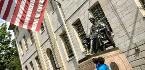 The bronze statue of John Harvard at Harvard University in Boston.