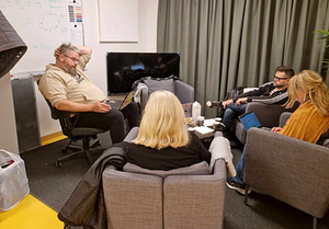 Fire personer sitter og drøfter i et arbeidsmøte hos Fryshuset.