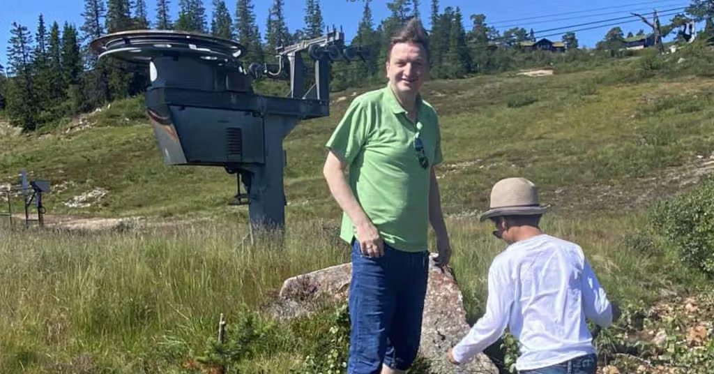 Vegard Mølstrevold and his son Axel, 7, explore the mountains under bright sunshine.